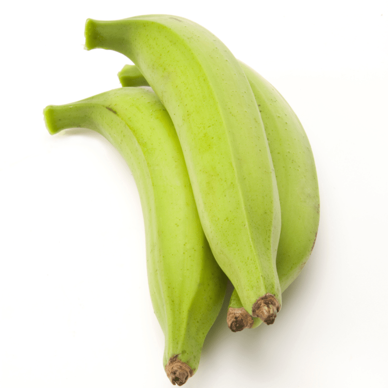 Three green plantains on white surface