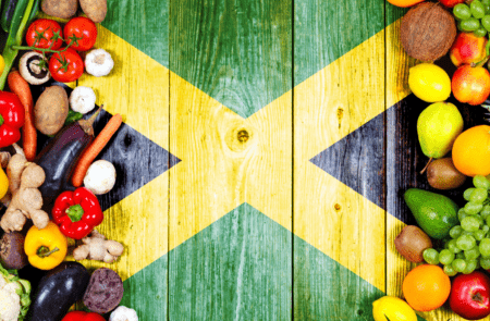 Jamaica flag background with fresh fruits and veggies on either side