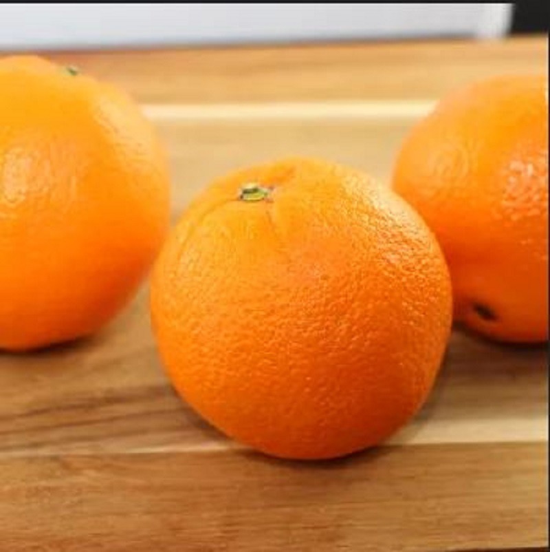 Ripe oranges on a counter